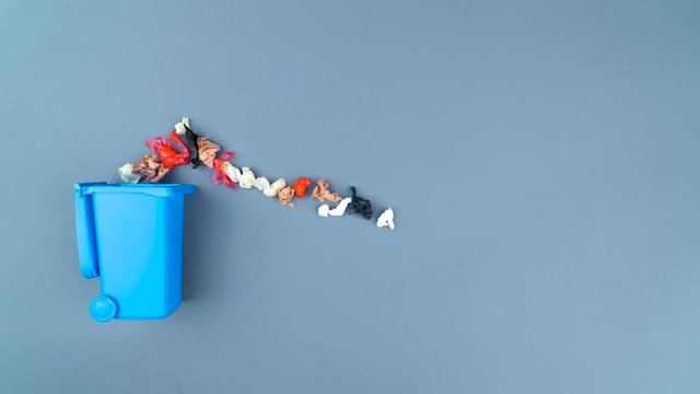 Stop motion of crumpled papers into a trash can