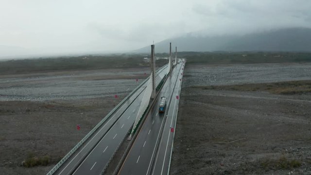 Aerial drone shot of bridge in Yuli Taiwan following truck