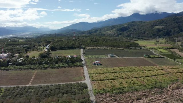 Aerial drone shot of landscape in Yuli Taiwan following bike in distance