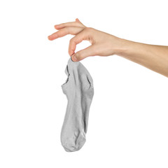 Hand holds dirty smelly sock. Close up. Isolated on a white background