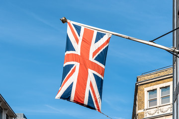 Union Jack UK flag waving against blue sky