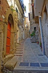 Fototapeta na wymiar Altavilla Silentina, Italy, 10/21/2017. A narrow street between the old houses of a medieval village