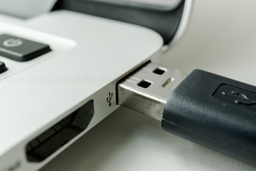 Black USB cable connected to laptop