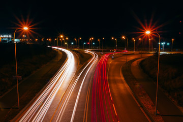 Fototapeta na wymiar Light car trails on highway roundabout at night. Traffic long exposure photo, Ceské Budejovice, Czech republic