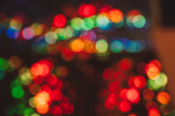 Background with round lights of blue, orange and red colors. Unfocused city streets