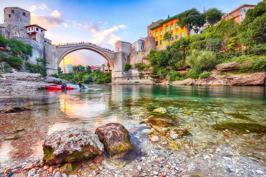 Fantastic Skyline of Mostar with the Mostar Bridge, houses and minarets, at sunset