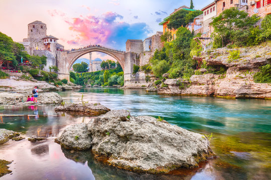 Fantastic Skyline of Mostar with the Mostar Bridge, houses and minarets, at sunset © pilat666