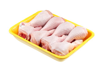 Chicken shin in yellow tray isolated on white background. Raw poultry meat