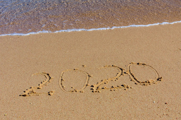 New year 2020. Inscription on a sandy beach. Tropical celebration concept