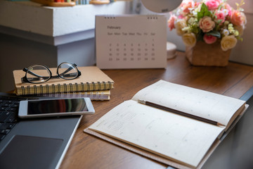 Planner and Calendar Concept.Desktop Calendar 2020,diary,smartphone and eyeglasses place on office desk.Notebook for Planner to set timetable,agenda and appointment.