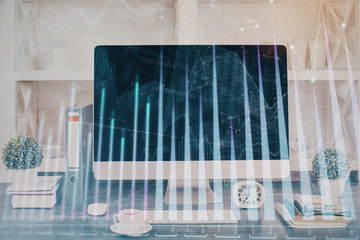Forex graph hologram on table with computer background. Double exposure. Concept of financial markets.