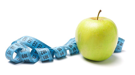 Apple and measuring tape on white background. Diet concept