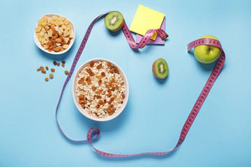 Different healthy food with measuring tape on color background. Diet concept