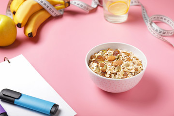 Different healthy food with measuring tape and notebook on color background. Diet concept