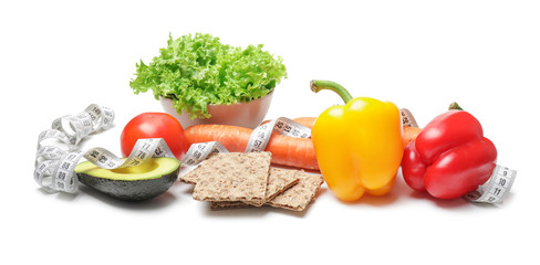 Different healthy food with measuring tape on white background. Diet concept