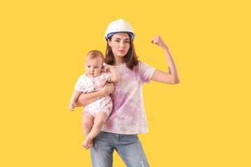 Young woman with baby on color background. Concept of feminism