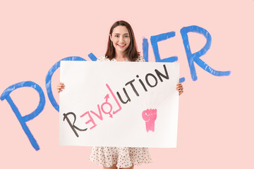 Young woman with poster on color background. Concept of feminism