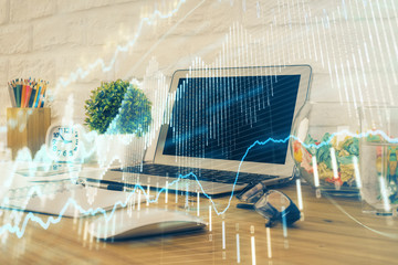 Financial chart drawing and table with computer on background. Multi exposure. Concept of international markets.