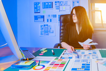 Woman working on mobile app design. Girl in a web design studio. Woman with a palette in her hands...