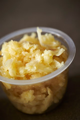 Crushed garlic in plastic bowl 