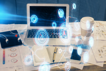 Double exposure of laptop computer and technology theme hologram. Concept of freelance work.