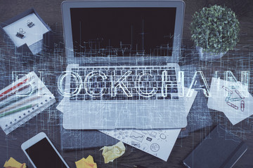 Double exposure of blockchain theme hologram and table with computer background. Concept of bitcoin crypto currency.