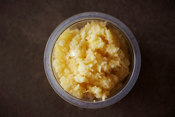 Crushed garlic in plastic bowl 