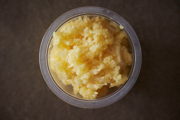 Crushed garlic in plastic bowl 