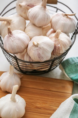 Basket with fresh garlic on table