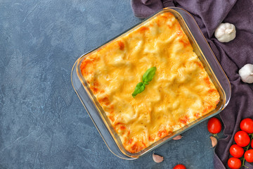 Tasty lasagna on dark background