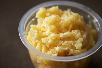 Crushed garlic in plastic bowl 