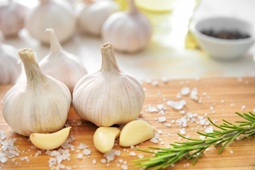 Fresh garlic with salt and herbs on board