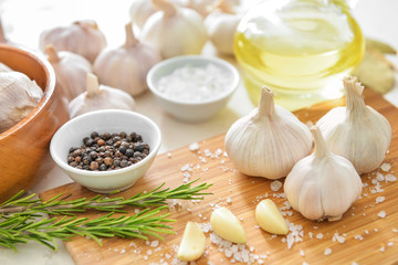 Fresh garlic with spices and herbs on table