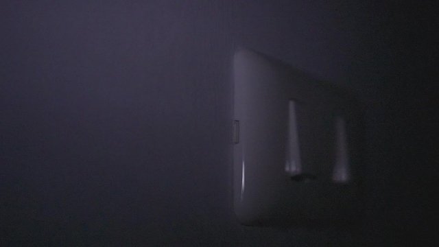 Close up hand switch off electric light . Concept of energy and power saving.