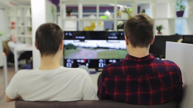 Two people playing console, work hard play hard