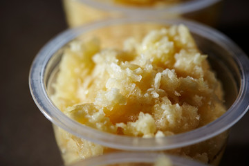 Crushed garlic in plastic bowl 