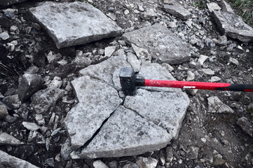 iron hammer breaking stone into pieces