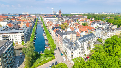 Fototapeta na wymiar Beautiful aerial view of Copenhagen skyline from above, Nyhavn historical pier port and canal with color buildings and boats in the old town of Copenhagen, Denmark