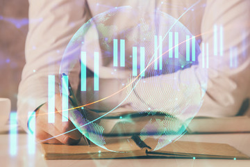 Financial trading chart double exposure with man desktop background.