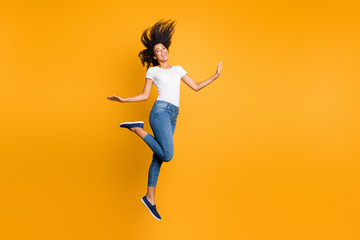Full length body size view of her she nice attractive lovely carefree cheerful cheery girlish wavy-haired girl jumping having fun isolated over bright vivid shine vibrant yellow color background