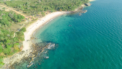 Fototapeta na wymiar Aerial drone view of tropical beach from above, sea, sand and palm trees island beach landscape, Thailand