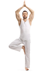 Man in white clothes standing in a meditation pose