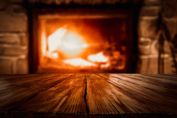 Winter background of wooden table and fireplace 