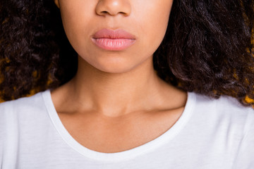 Close up cropped photo of tender feminine lips applied with balm treating about them well using no lipstick pomade with facial expression serious