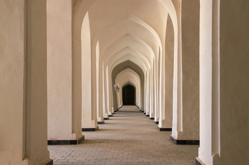 Fototapeta na wymiar Corridor of arches in the Bukhara city