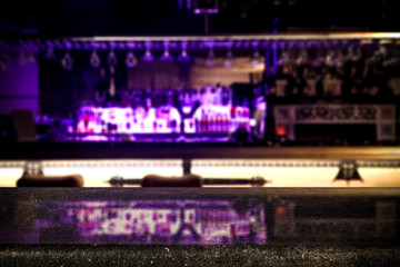 Desk of free space and blurred background of bar 