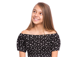 Beautiful teen girl smiling looking away. Portrait of young pretty funny child with perfect smile and white teeth, isolated on white background. Young happy teenager posing in studio.