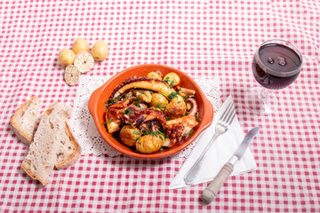 Grilled ocotpus with potatoes, garlic and salsa.