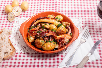 Grilled ocotpus with potatoes, garlic and salsa.