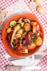 Grilled ocotpus with potatoes, garlic and salsa.